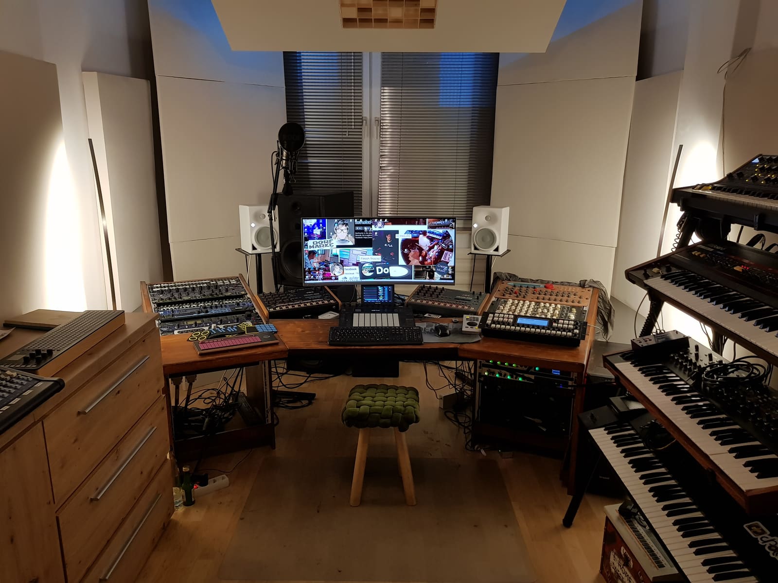 Past Dorfmarke studio setup with synthesizers, drum machines, sequencers, and monitoring equipment.